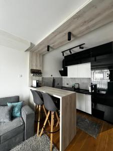 a kitchen and living room with a table and a couch at Emma Park Lake Emma Parklake in Tuzla