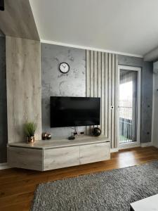 a living room with a flat screen tv on a wall at Emma Park Lake Emma Parklake in Tuzla