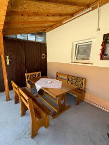 a patio with a table and chairs in a room at Green Village Life in Katun