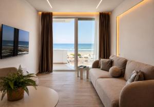 a living room with a couch and a view of the ocean at DoR Stay Seaside in Durrës