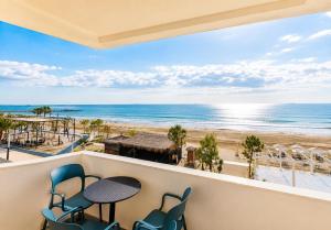 a balcony with a table and chairs and the beach at DoR Stay Seaside in Durrës