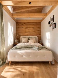 a bedroom with a large bed with wooden ceilings at Das Seehaus Buckow in Buckow