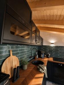 a kitchen with a sink and a stove top oven at Das Seehaus Buckow in Buckow +23 photos