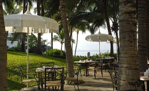 a group of tables and chairs with umbrellas at Mayan Palace at Vidanta Vallarta in Puerto Vallarta +8 photos