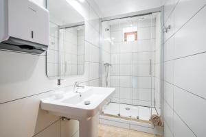 a white bathroom with a sink and a shower at Hostal Miramar in Deia +23 photos