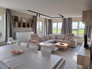 a living room with a couch and a table at 't Ooievaarszicht in Veurne