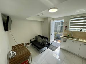 a living room with a couch and a kitchen at Budget Friendly 2 Bedroom Suite - Save on Weekly and Monthly Stays! in New Westminster