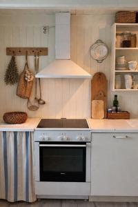 a kitchen with a stove and a white oven at Pålberget in Råkvåg