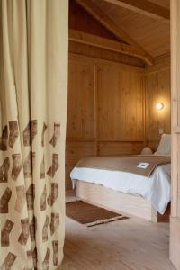 a bedroom with a bed and a curtain at Yogi's Cabin in Battle