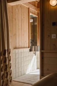 a bathroom with a shower with a sink and a mirror at Yogi's Cabin in Battle +71 photos