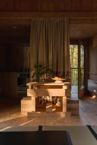 a living room with a table and a kitchen at Yogi's Cabin in Battle
