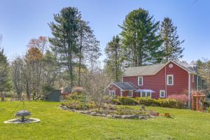a red house with a garden in front of it at Tranquil Catskills Home w/ Creek & Fire Pits in Parksville