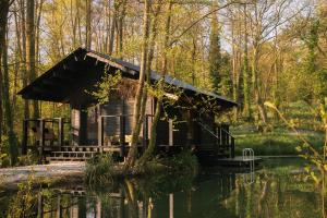 a cabin in the middle of a pond at Yogi's Cabin in Battle