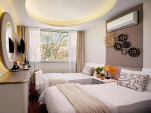 a hotel room with two beds and a window at İS Hotel in Antalya
