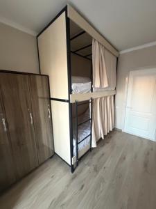 a room with an empty closet with a door at Bayan hostel in Osh
