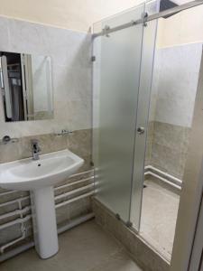 a bathroom with a sink and a shower at Bayan hostel in Osh