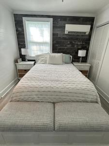 a bedroom with a large bed with two night stands at Chucks Cottage in Cape Charles in Cape Charles