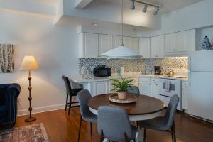 a kitchen with a table and chairs and a kitchen with white cabinets at 3rd Street Flats in McMinnville