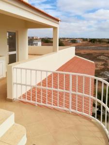 a balcony with a white railing on a house at Ponta Preta Village 9 in Vila do Porto
