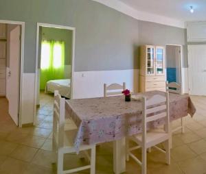 a dining room with a table and chairs and a bedroom at Ponta Preta Village 9 in Vila do Porto
