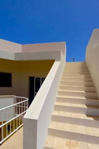 a staircase leading up to a building with a blue sky at Ponta Preta Village 9 in Vila do Porto