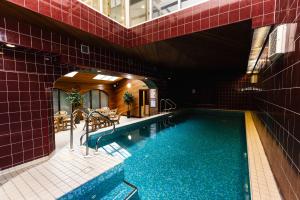a swimming pool in a building with red tiles at Honeysuckle in Wooler