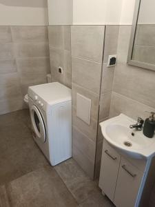 a bathroom with a washing machine and a sink at OLD TOWN Olsztyn in Olsztyn