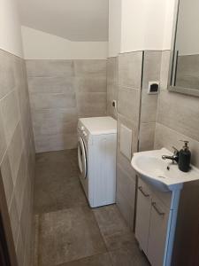 a bathroom with a washing machine and a sink at OLD TOWN Olsztyn in Olsztyn