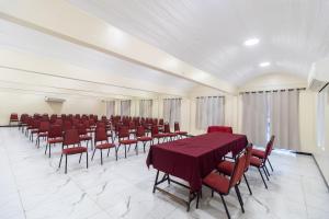 a large room with red chairs and tables and a room with at Nobile Hotel Belém in Belém