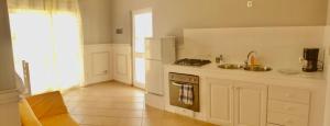 a kitchen with a sink and a stove at Ponta Preta Village 10 in Vila do Porto +6 photos