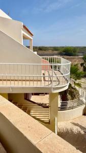a house with a staircase leading to the beach at Ponta Preta Village 10 in Vila do Porto