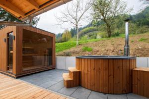 a hot tub on the deck of a house at Rotbauernhof - Chalet - in Gutach