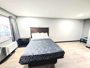 a bedroom with a bed in a room at BlissPoint Inn Muncie in Muncie