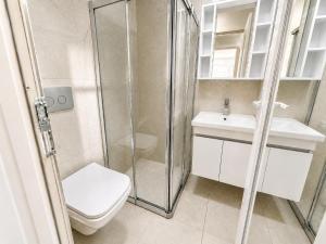 a bathroom with a shower and a toilet and a sink at Villa Sena in Dalyan +7 photos