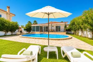 a villa with a swimming pool and an umbrella at Villa Sena in Dalyan