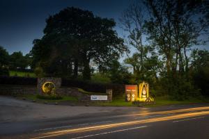 a sign on the side of a road with lights at Pinetum Garden Cottages in St Austell +62 photos
