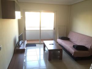 a living room with a couch and a coffee table at Apartamentos EOS in Buzanada