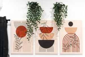 a group of four posters with plants in vases at Suite Gli Ulivi in Colonna