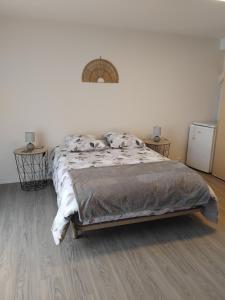 a bedroom with a bed and two night stands at Chambre in Château-Garnier