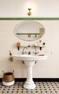 a bathroom with a white sink and a mirror at Chambre dans villa privée, charme et confort proche Vélodrome & plages - Parking privé in Marseille