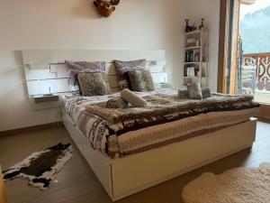 a bedroom with a large bed in a room at Perle de Savoie Free multipass offer for 4 guests in Châtel
