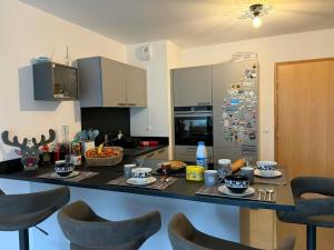a kitchen with a table with food on it at Perle de Savoie Free multipass offer for 4 guests in Châtel +11 photos