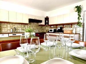 a table with wine glasses on it in a kitchen at Ferienhaus "Kleine Auszeit" in Tieschen +14 photos