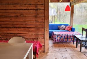 a living room with a blue couch and a table at Oandu Camping in Oandu