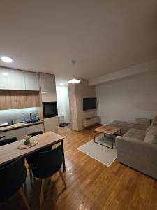 a living room with a couch and a table at Vila#Borova#800m in Zlatibor
