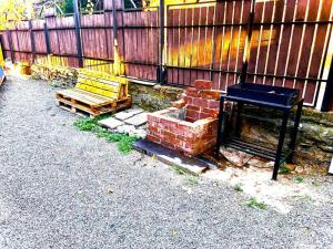 a bench sitting next to a wooden fence at Cestlavie in Mtskheta