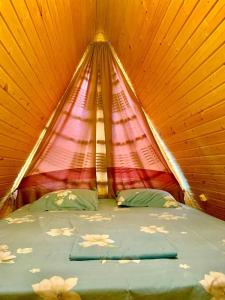 a large bed in a tent with a roof at Cestlavie in Mtskheta