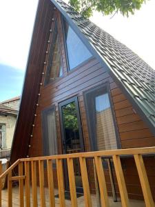 a house with a large window on a deck at Cestlavie in Mtskheta
