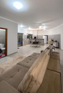 a large couch in a living room with a table at Recanto Rafaela 2 in Olímpia