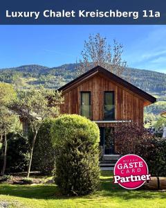 a house with a sign in front of it at Luxury Chalet Kreischberg 11a in Sankt Lorenzen ob Murau